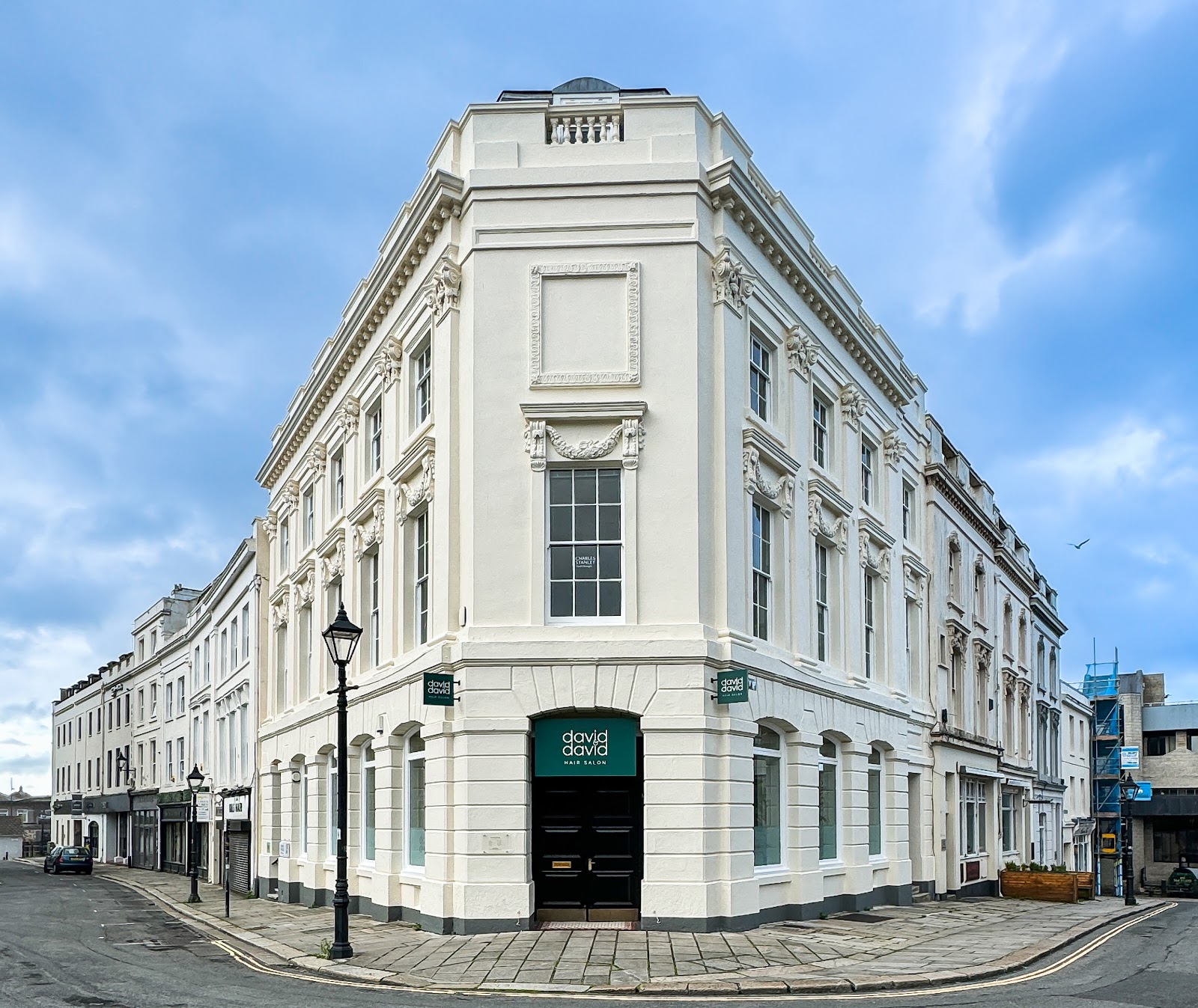 A grand white-painted Plymouth corner building, exterior repaint by Top Coat Decorators